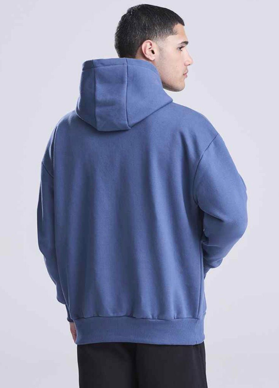man wearing a dark blue hoodie looking away from the camera