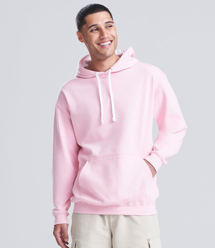 man wearing a pink hoodie looking at the camera