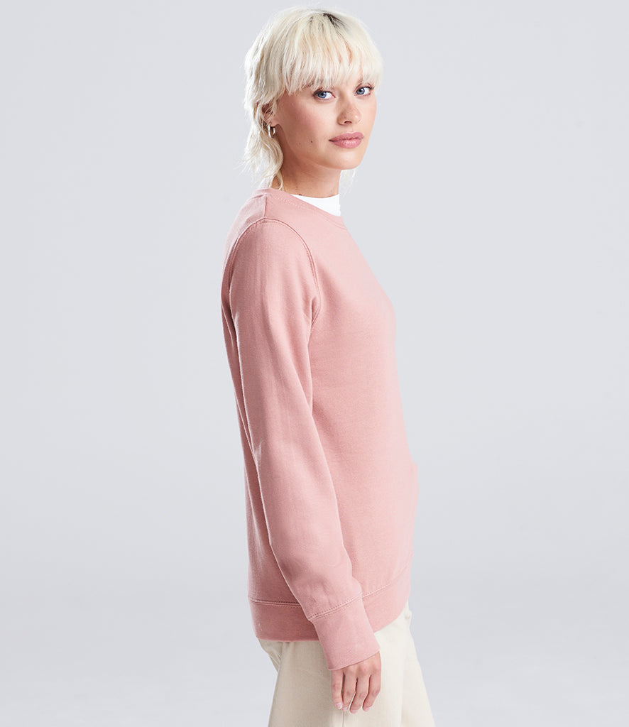 woman wearing a pink sweatshirt looking at the camera