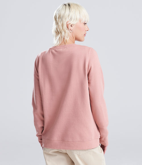 woman wearing a pink sweatshirt looking away from the camera
